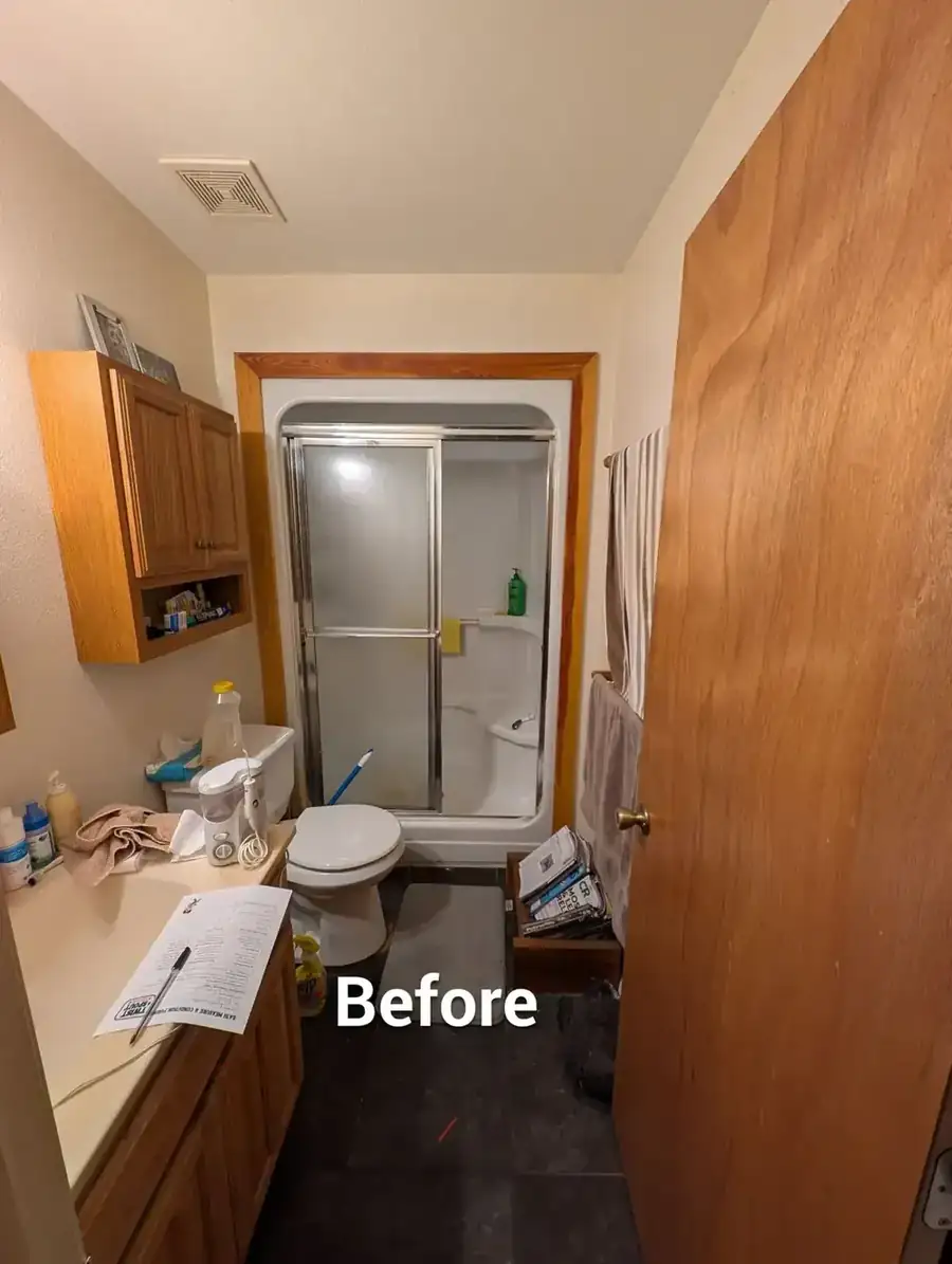 The small bathroom before the conversion, with the original bathtub in place